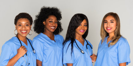 Four Healthcare workers smiling at the camera