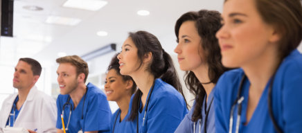 Nurses listening to the person speaking in front